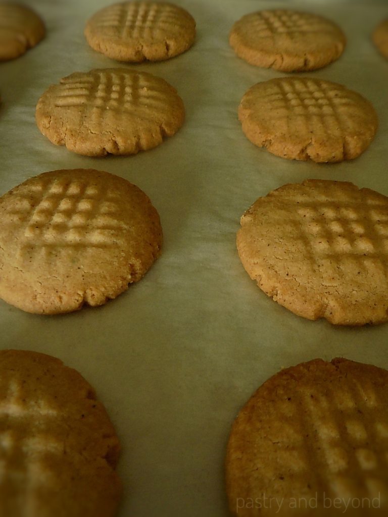 Baked cinnamon cookies on a parchment paper.