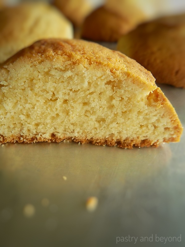 Cake-like vanilla cookie cut in half showing the inside.