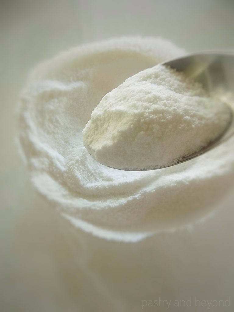 Homemade powdered sugar on a spoon.