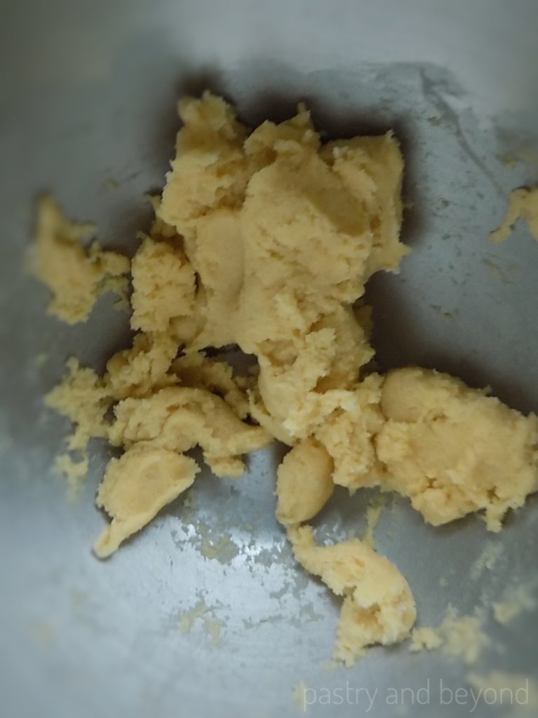 Dough of a cookie stick in a mixer bowl.