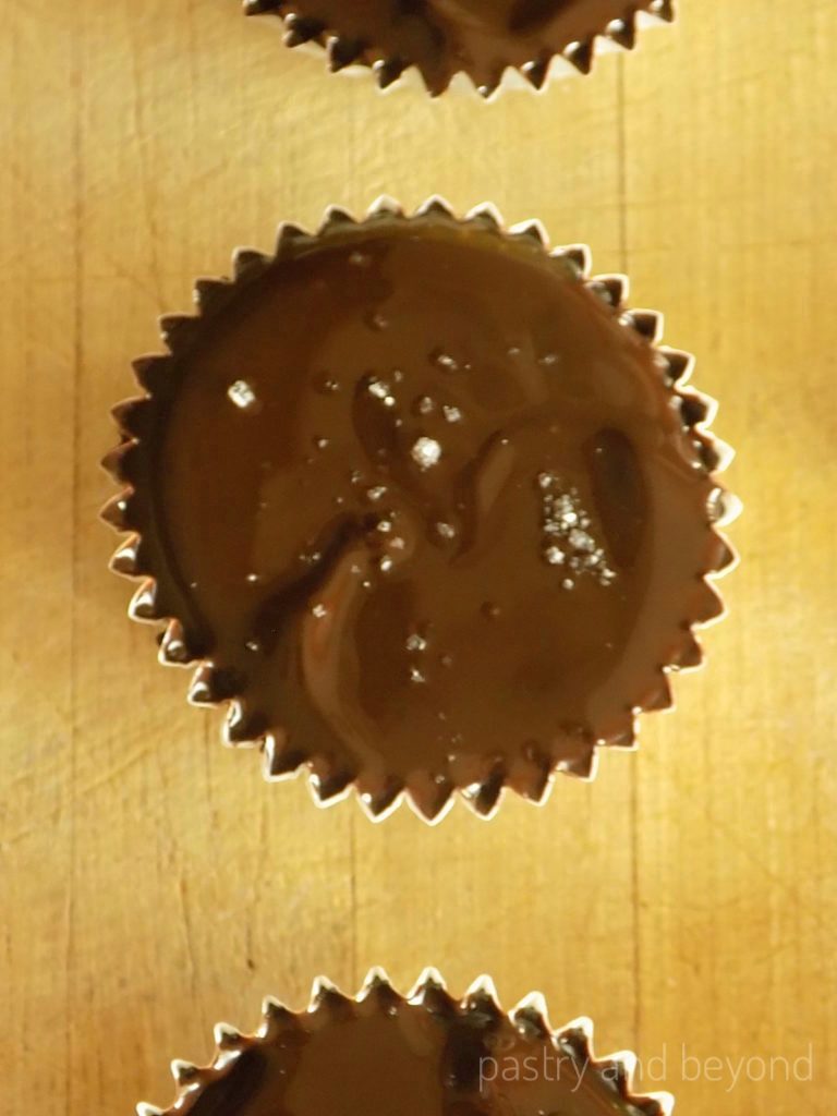 Overhead view of caramel chocolate cup with sea salt on top.
