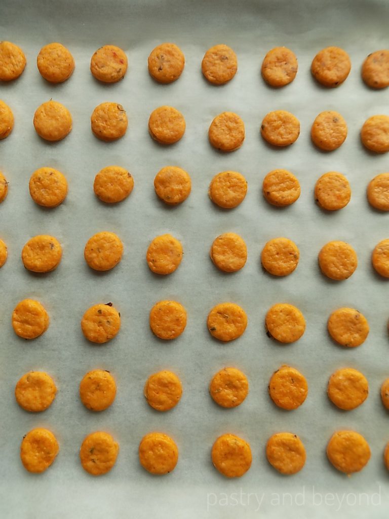 Pizza crackers on a parchment paper before baking.