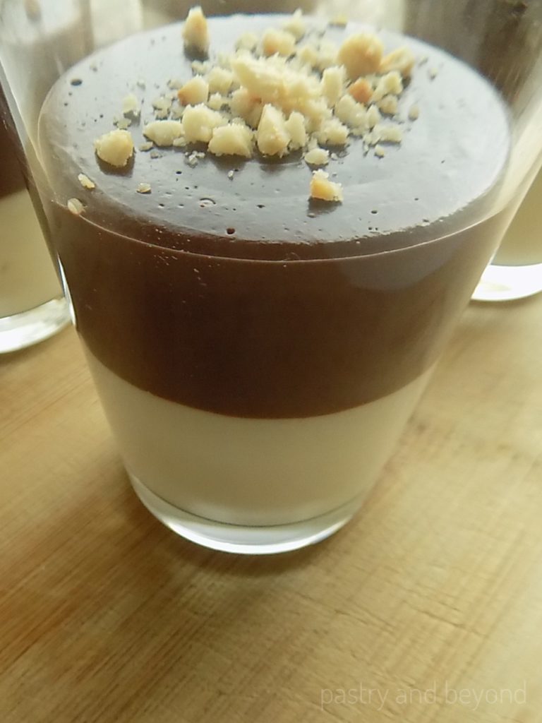 Vanilla and chocolate pudding with hazelnuts on top.