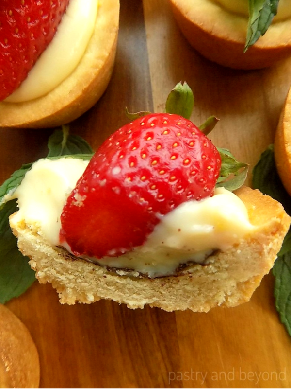 Strawberry mint cookie cup with pastry cream that is cut in half.
