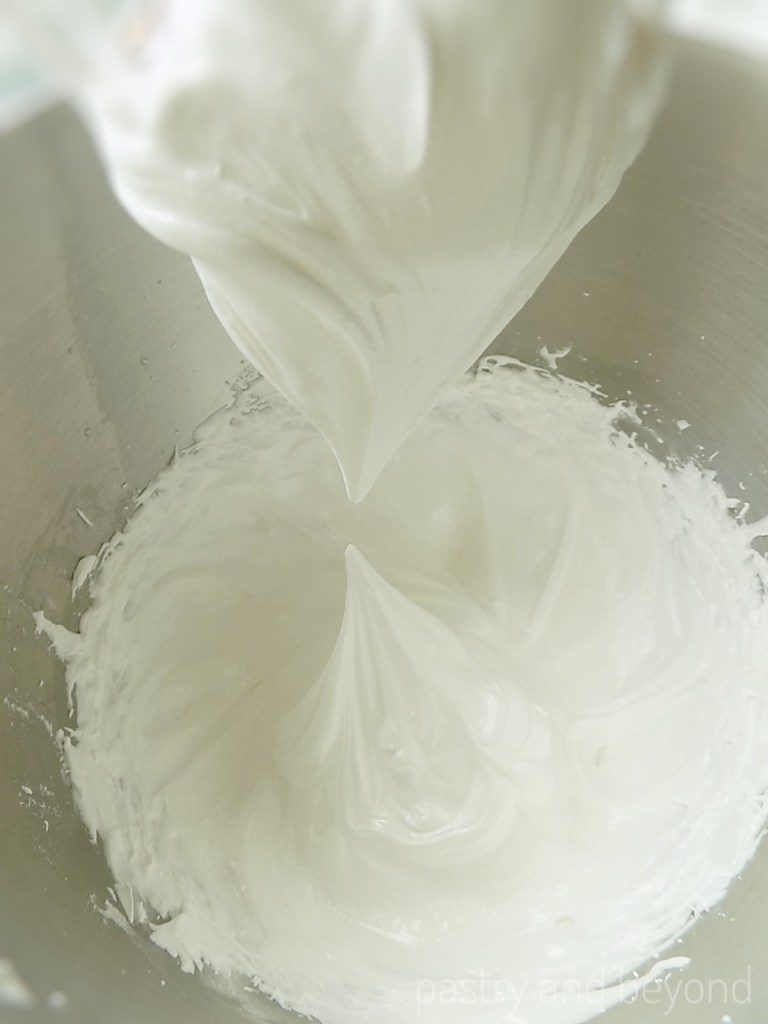 Swiss meringue at stiff peak after whisked. Meringue points straight up, doesn't form a hook.