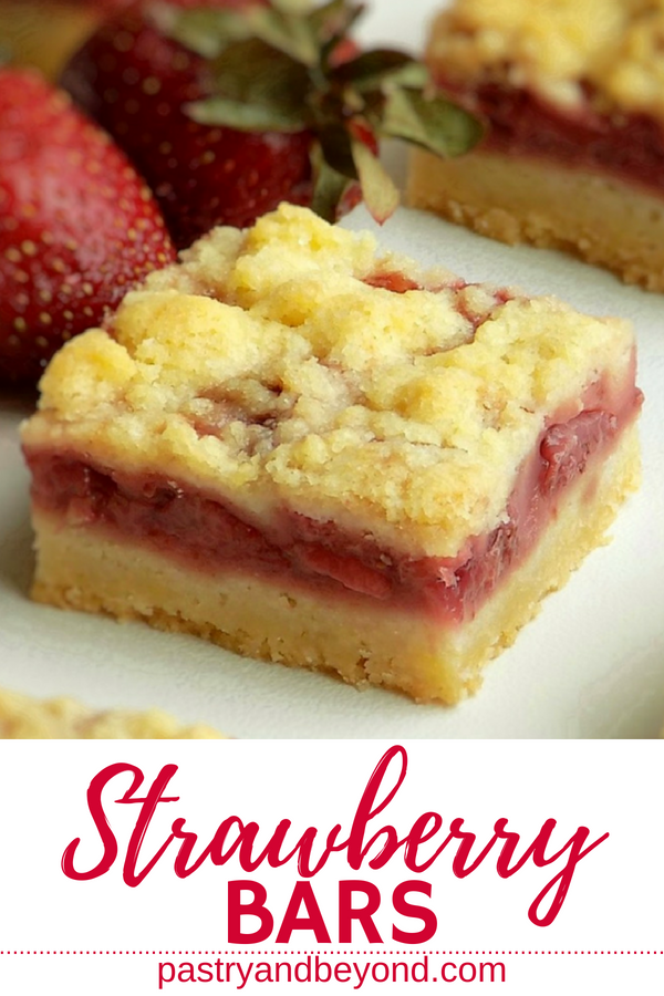 Strawberry crumble bar with strawberries in the background. 