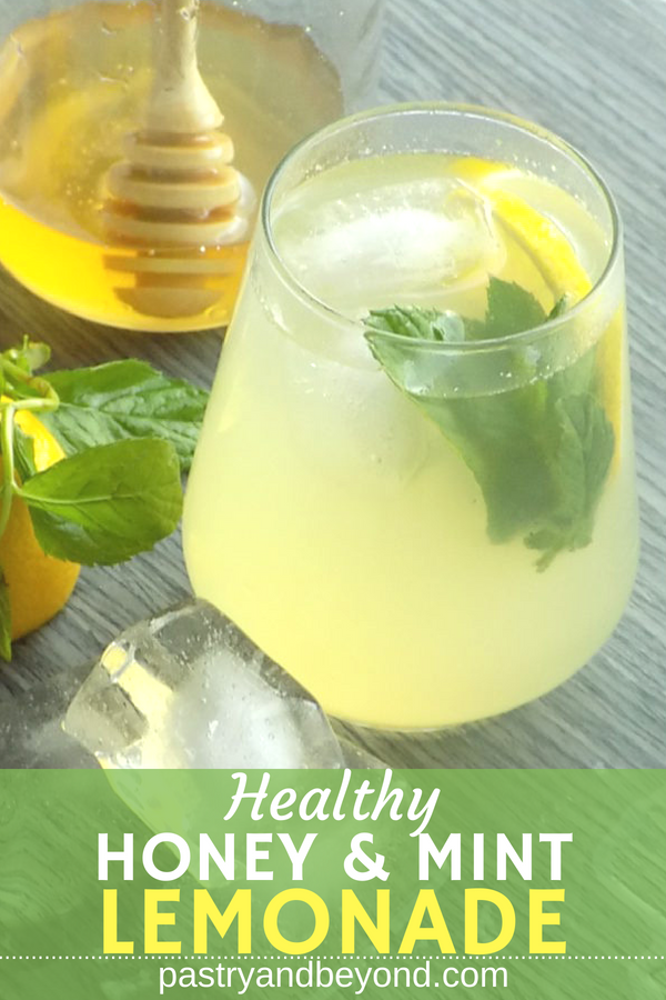 Lemonade in a glass with lemon slices and mint leaves.