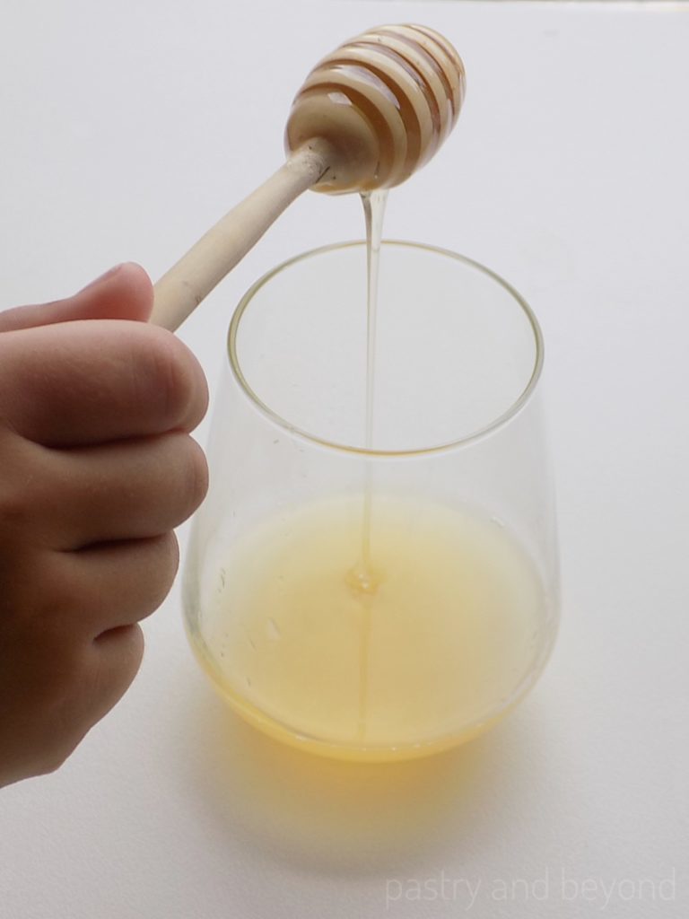 Adding honey into the lemon juice.