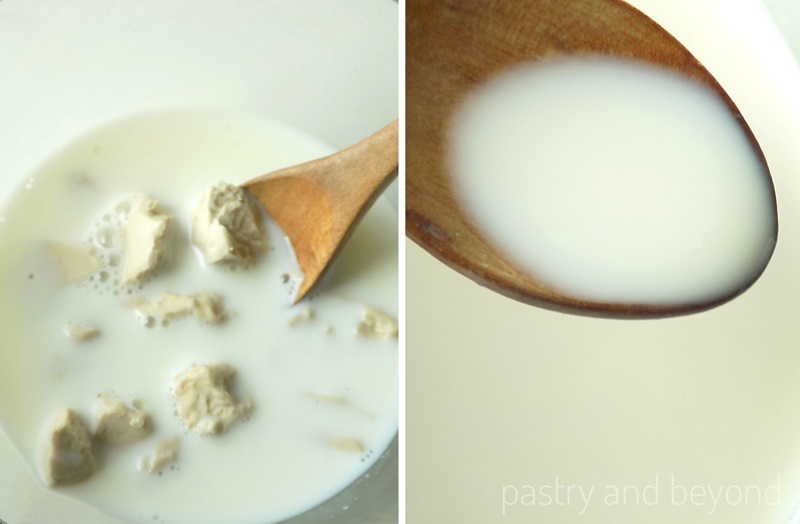 Fresh yeast is dissolved with milk using a wooden spoon in a small glass bowl.
