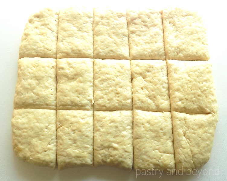 Making a rectangle out of the dough and cut into fifteen pieces on a work surface.