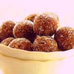 Almond date balls in a white bowl.