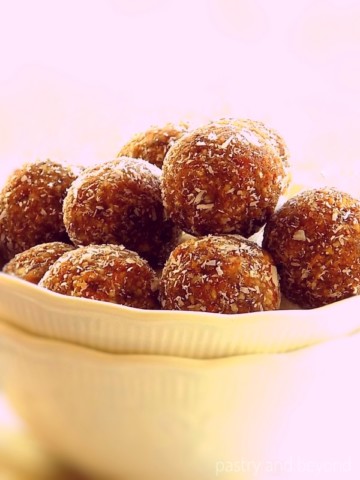 Almond date balls in a white bowl.