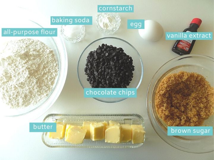 Ingredients for chocolate chip cookie cake on a white surface.