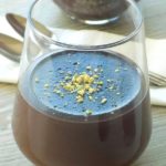 Easy chocolate pudding in a serving glass with pistachios on top.