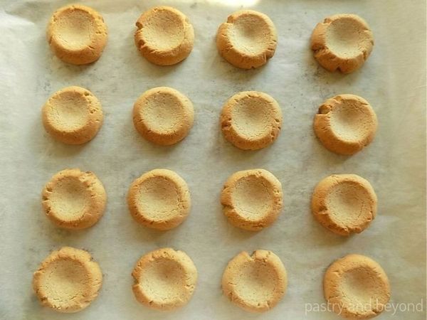 Baked cookies on a parchment paper lined baking sheet. 