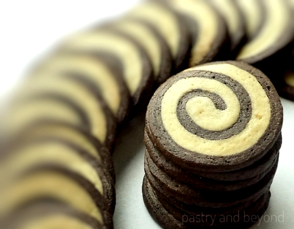 Stacked swirl cookies on a white surface.