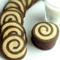 Vanilla and chocolate swirl cookies with a glass of milk.