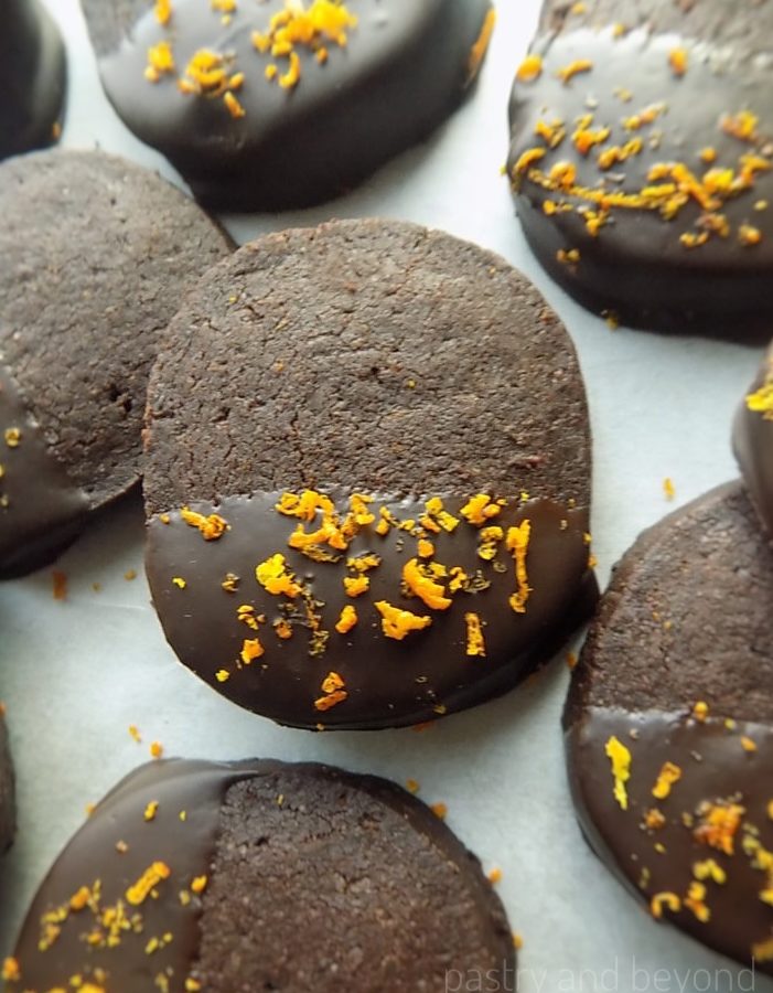 Slice-and-bake chocolate orange shortbread cookies on a white surface.