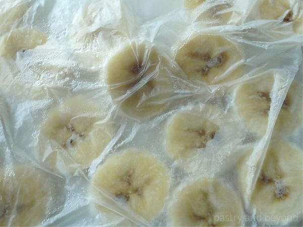 Frozen banana slices in a freezer bag.