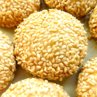 Sesame cookies on a white surface.