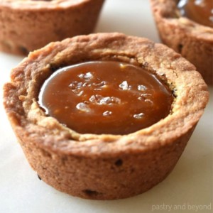 Caramel filled chocolate chip cookie cups with sea salt on top.