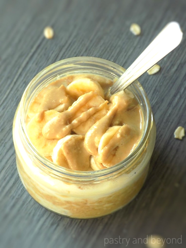 Gluten free peanut butter banana overnight oats in a jar with a spoon.