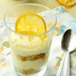 Lemon curd mousse with candied lemon slice in a glass.