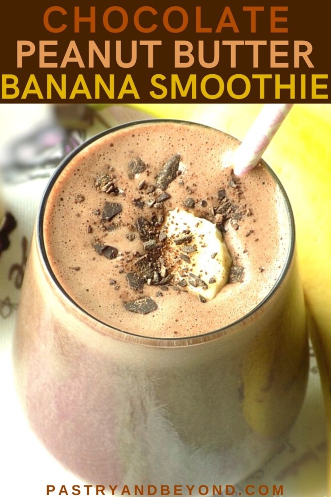 A glass of chocolate peanut butter smoothie with shredded chocolate and banana slice.