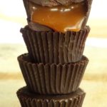 Stacked mini caramel chocolate cups.