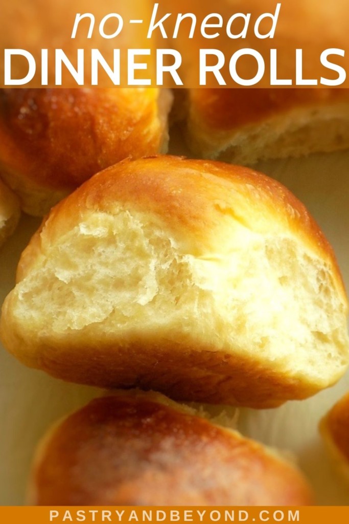 Soft dinner rolls on a parchment paper.