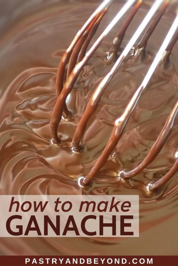 Chocolate ganache in a bowl with a whisk.
