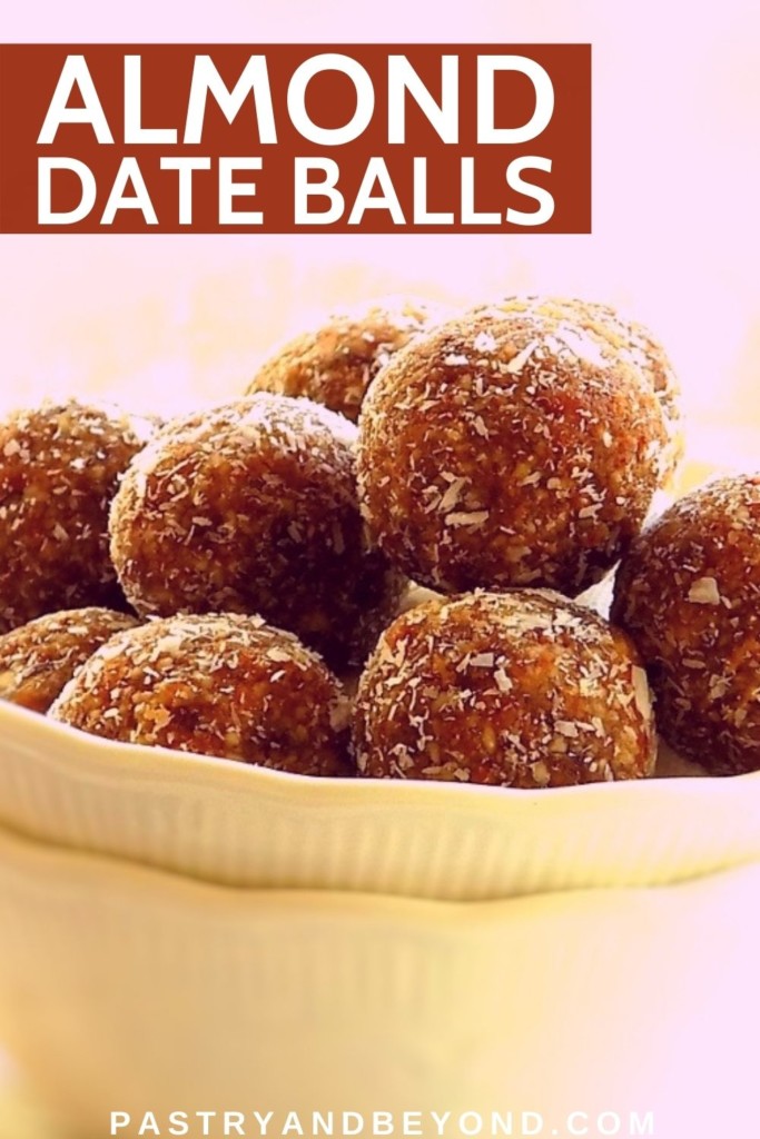 Almond date balls in a bowl on top of each other.