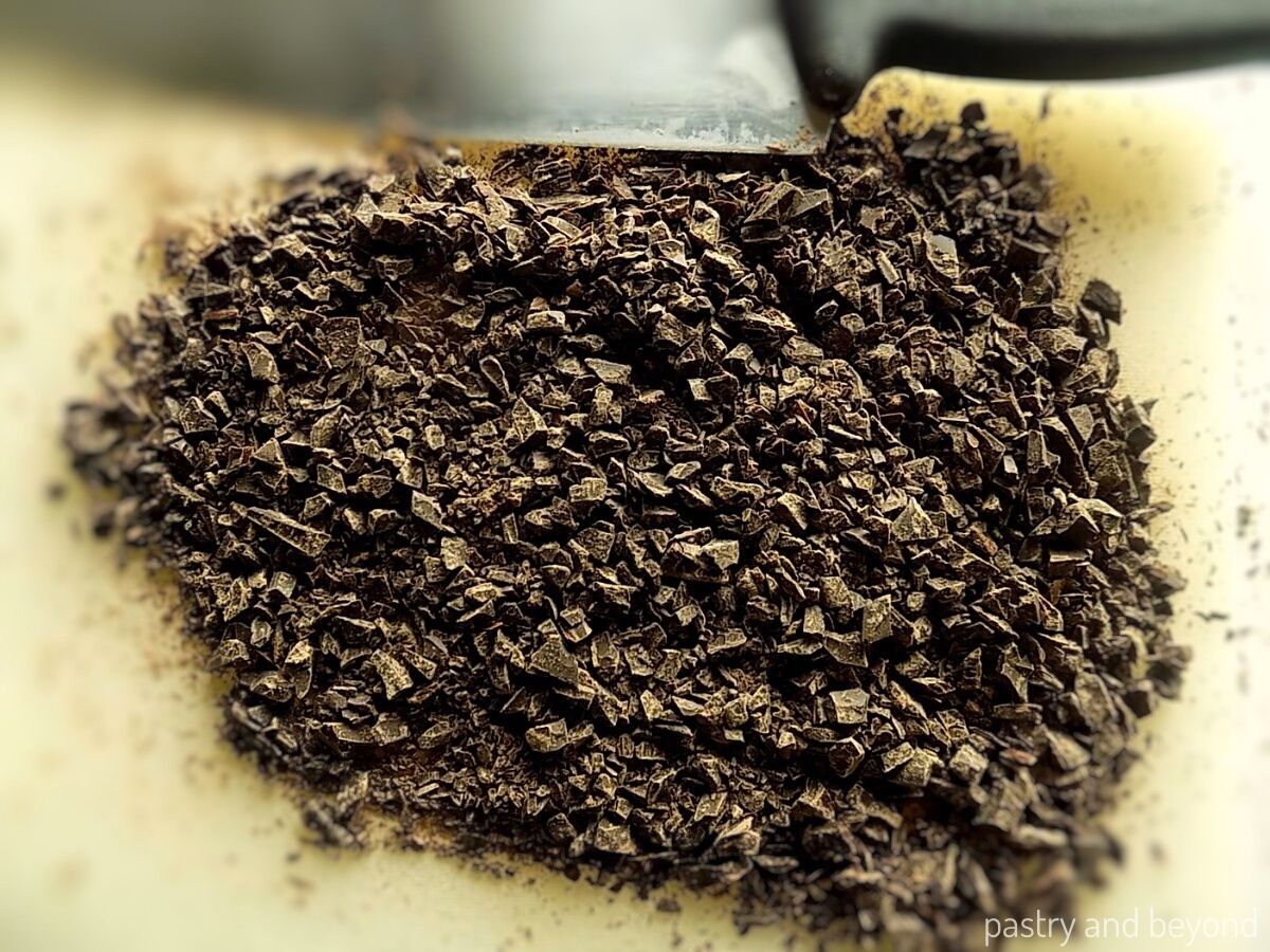Chocolate chopped into small pieces to be used in a brownie recipe.
