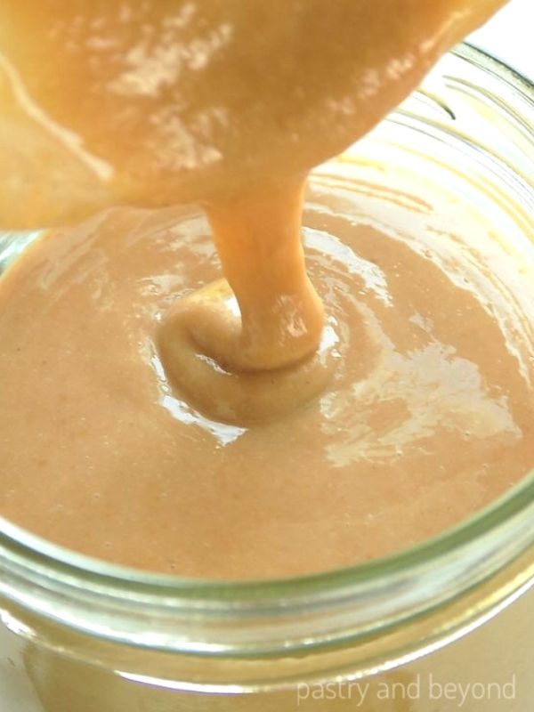 Pouring the homemade tahini into a jar. 