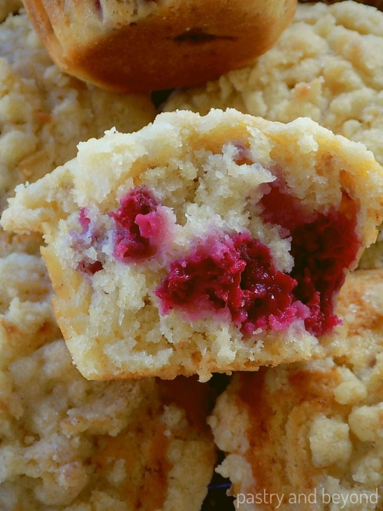 Half of the raspberry muffin on top other muffins. 