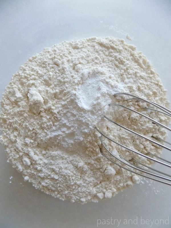 Flour and baking powder in a medium bowl with a whisk.