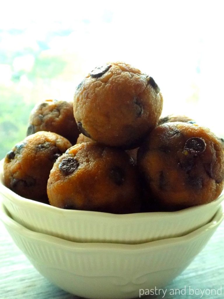 Peanut butter oat balls with chocolate chips in a white bowl.