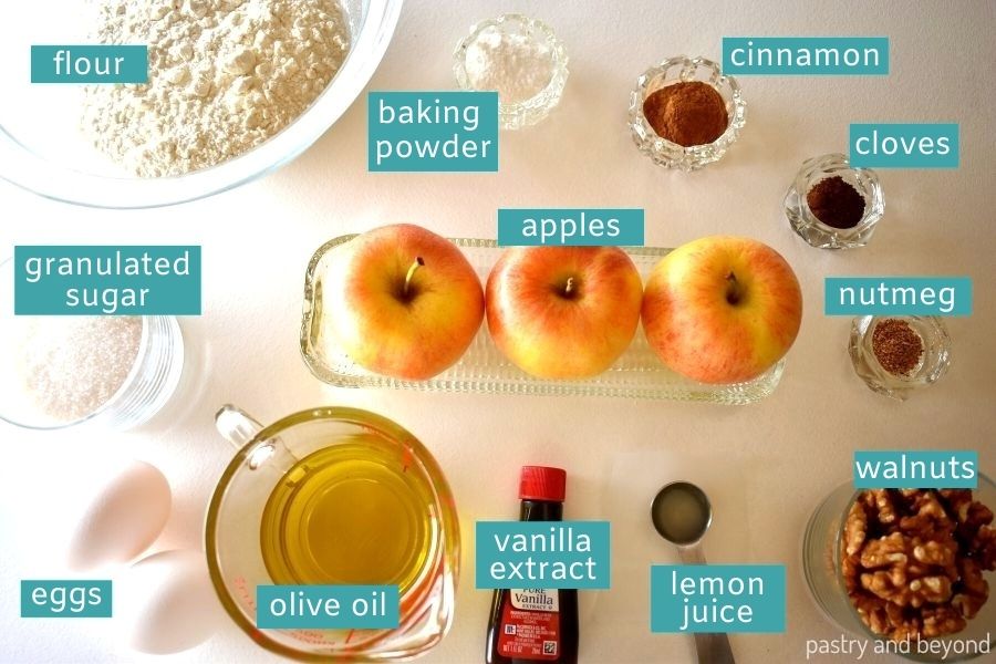 Ingredients for apple cake loaf on a white surface.