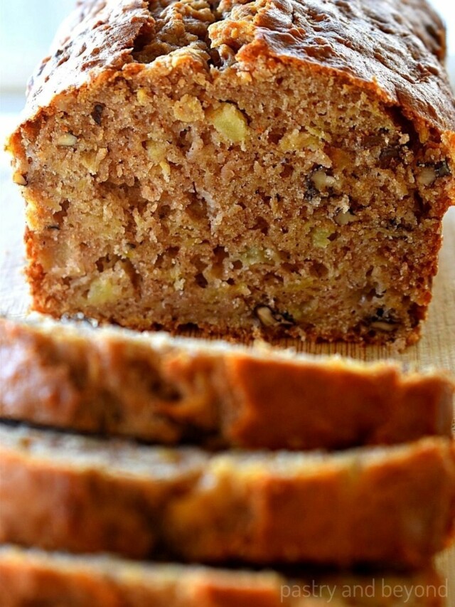 Apple cake loaf that is cut imto slices.