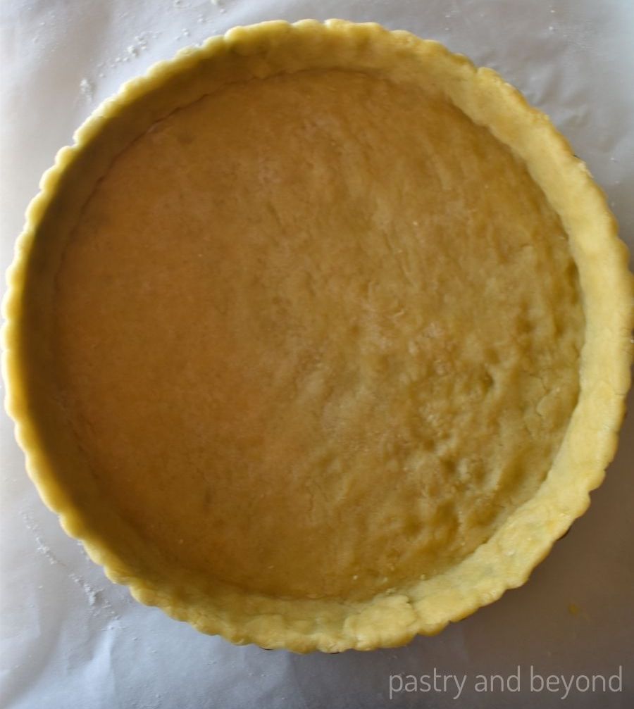 Unbaked tart dough in a tart pan.