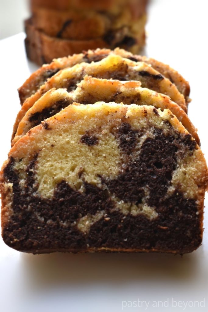 Slices of marble cake loaf in a row.