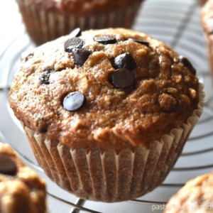 Banana oatmeal chocolate chip muffins on a wire rack.