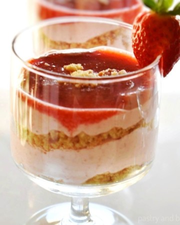 Strawberry mousse, crushed almond cookies and a strawberry puree as layers in a serving glass.
