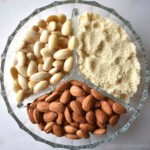 Blanched almonds, almond flour and raw almonds in a glass plate with three segments.