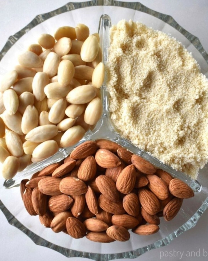 Blanched almonds, almond flour and raw almonds in a glass plate with three segments.