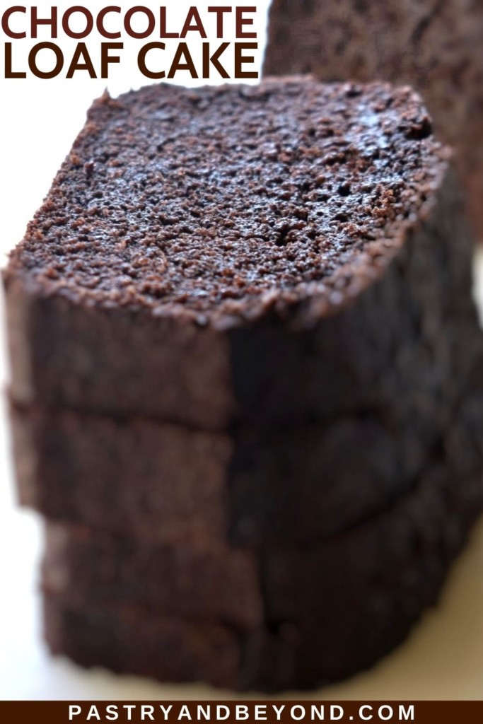 Stacked chocolate loaf cake slices on a white surface.