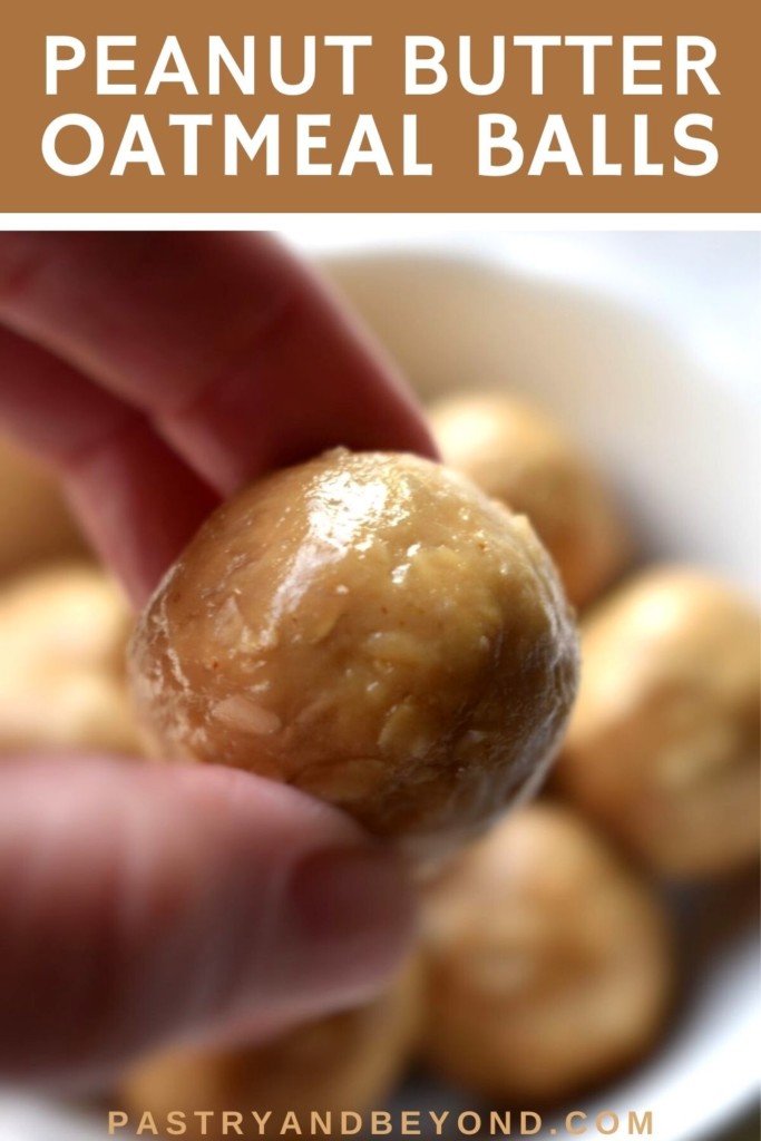 A hand holding peanut butter oatmeal ball.