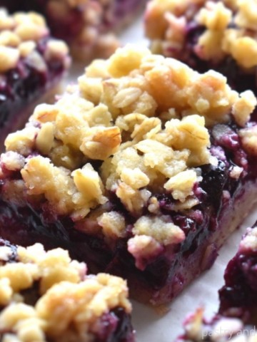 Blueberry oatmeal crumble bars on a parchment paper.