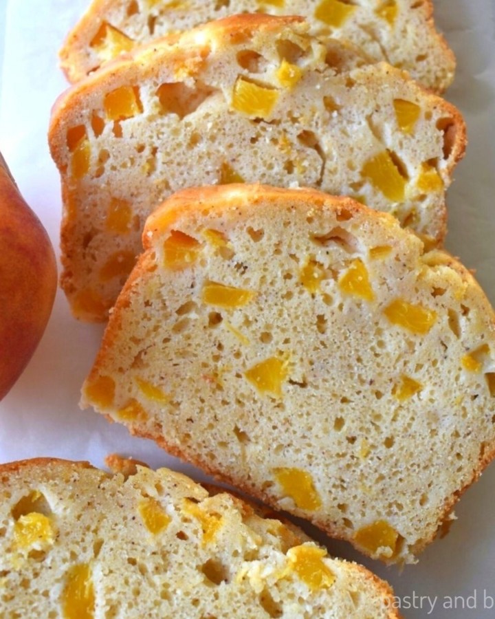 Slices of peach bread on a white surface.