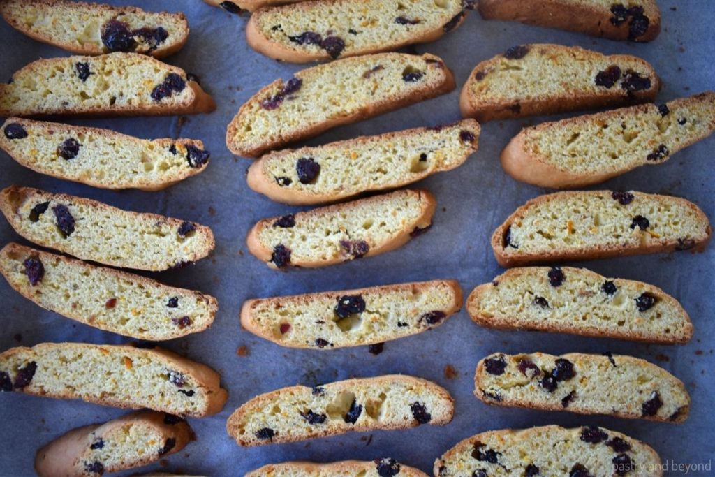 Biscotti slices on a parchment paper.